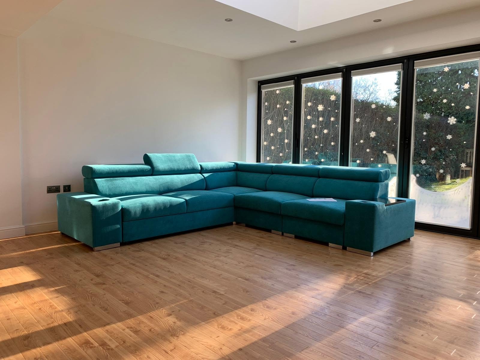 Teal corner sofa bed in a customer's living room