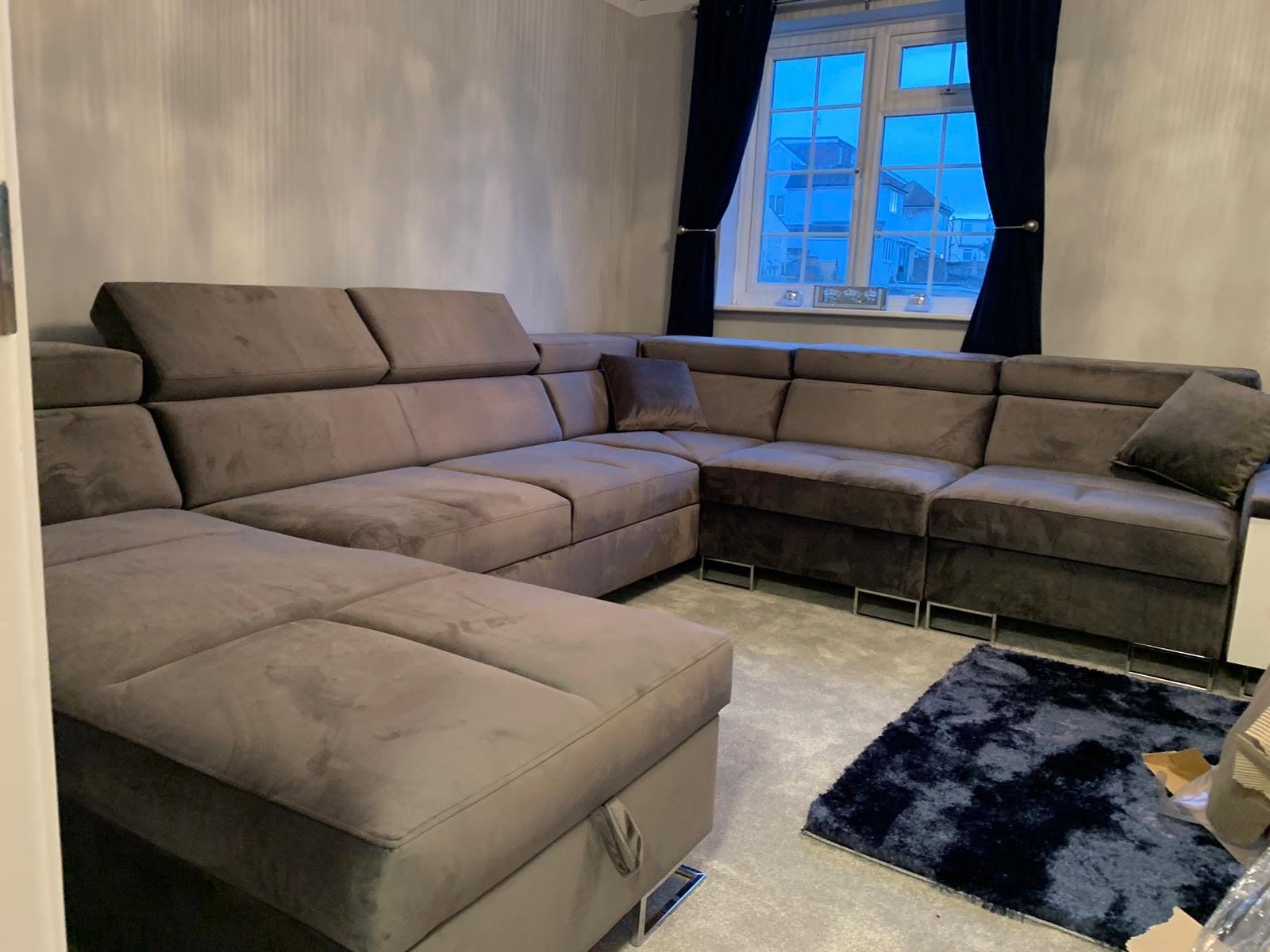 Brown U-shaped corner sofa bed in a customer's lounge